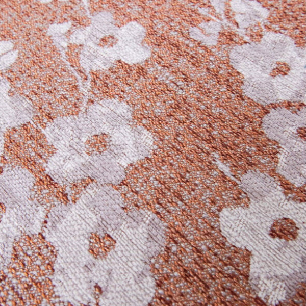 Close-up of Louis De Poortere Sakura rug featuring textured floral pattern in soft white and warm terracotta tones