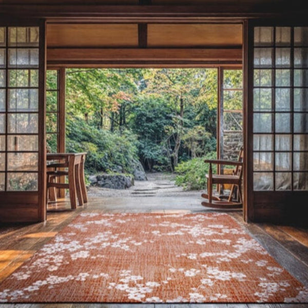 Louis De Poortere Sakura rug in a traditional Japanese room with wooden floor and garden view