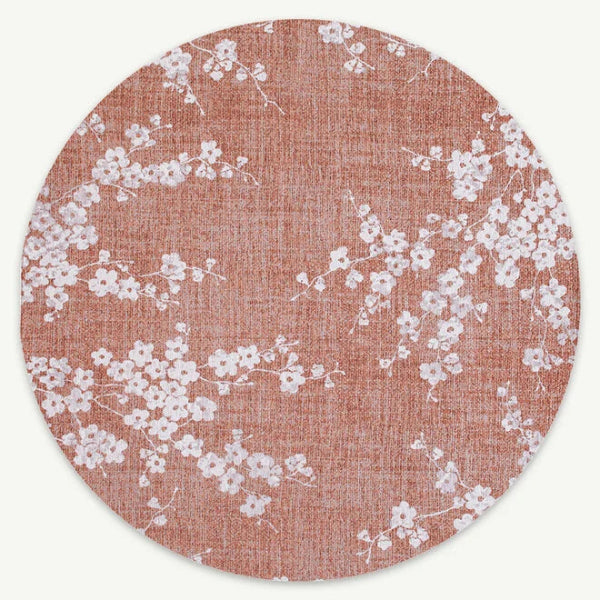 Round Louis De Poortere Sakura rug with delicate white cherry blossom pattern on soft pink background