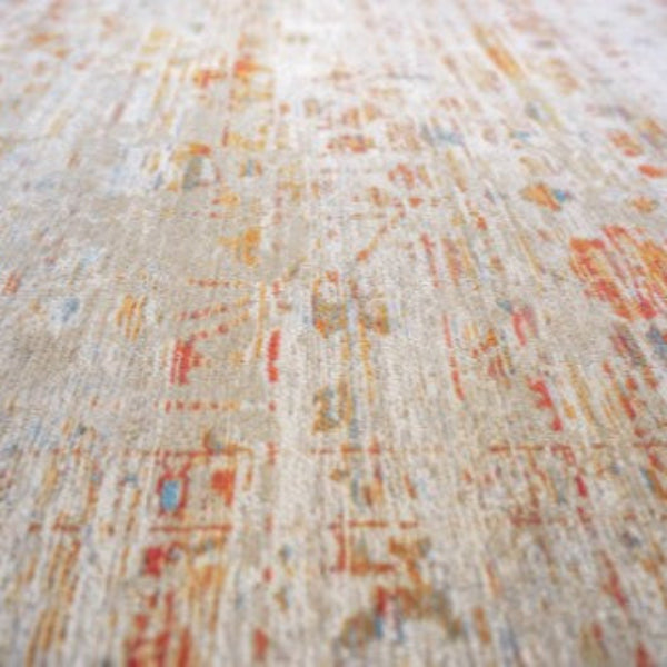 Close-up of Louis De Poortere Ushak rug showing intricate faded patterns in warm tones