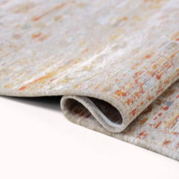 Close-up of folded Louis De Poortere Ushak rug showing detailed textured weave and subtle colour variations