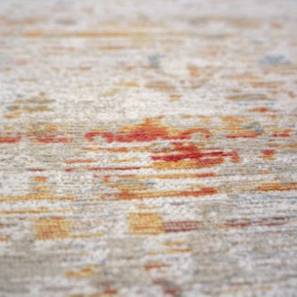 Close-up view of a Louis De Poortere Ushak rug with intricate patterns and a blend of warm colours