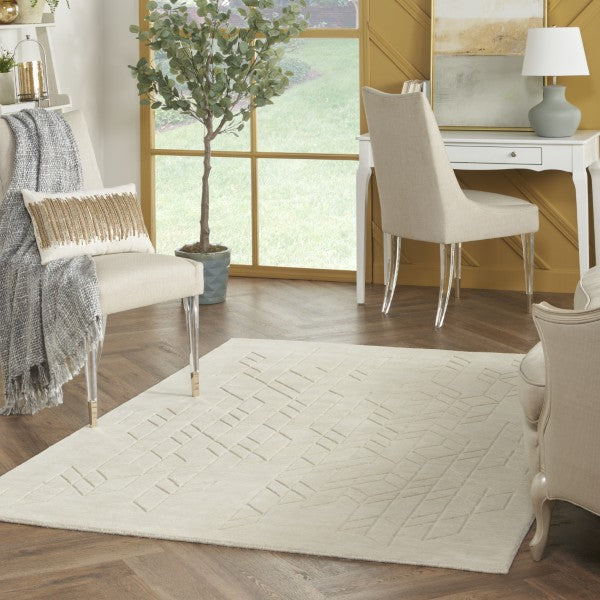 Luxury living room featuring a cream textured Nourison Alessia rug with modern furniture and natural light