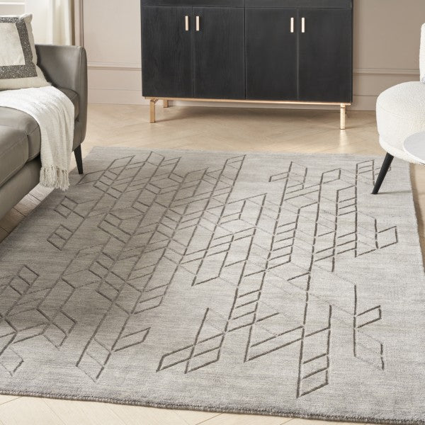 Luxury grey Nourison Alessia rug with geometric pattern in modern living room setting