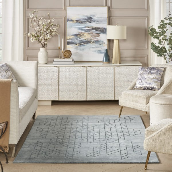 Elegant living room featuring a Nourison Alessia rug with geometric pattern in soft grey tones