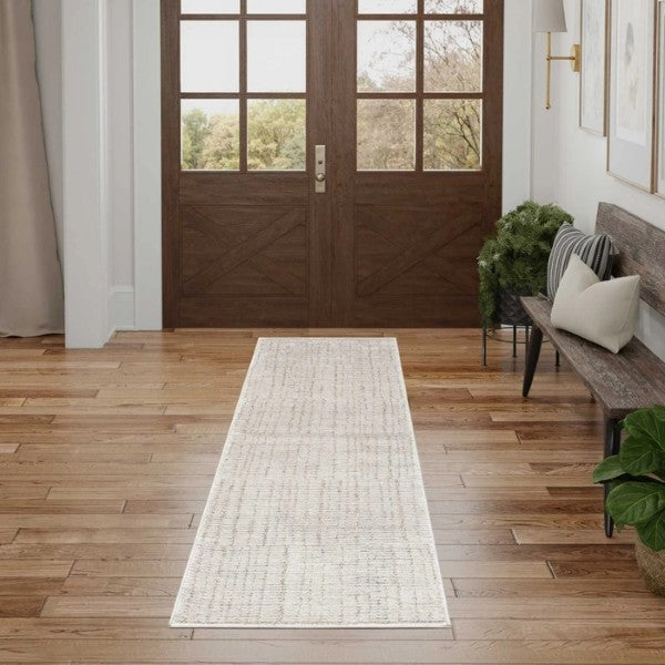 Neutral toned Nourison Andes Rug Collection luxury rug runner in a modern hallway with wooden floor and dark wood door