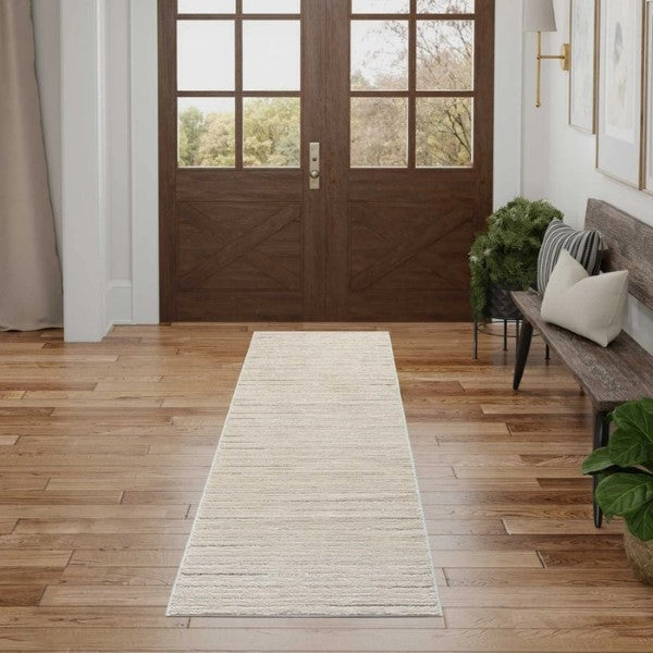 Luxury beige runner rug from Nourison Andes Rug Collection placed in bright entryway with wooden doors