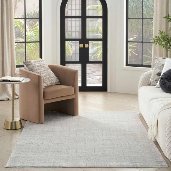 Luxury beige Nourison Andes Rug Collection placed in modern living room with armchair and sofa