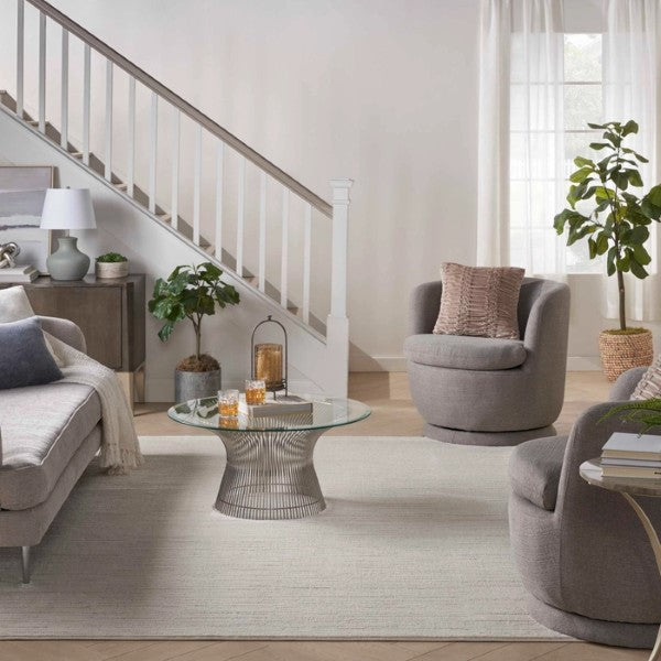 Nourison Andes Rug Collection luxury rug in modern living room with grey chairs and glass coffee table
