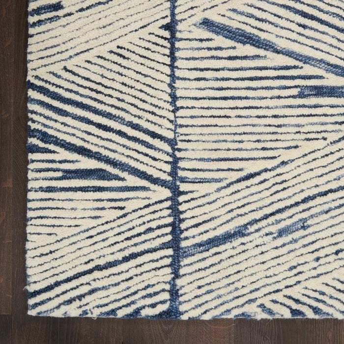 Close-up of Nourison Colorado Rug Geometric Design in blue and white luxury rug on wooden floor