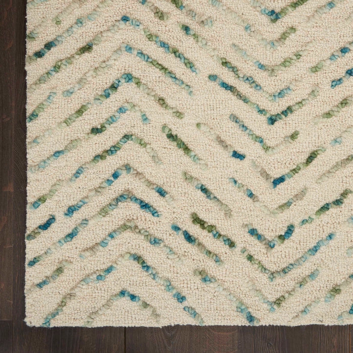 Close-up of Nourison Colorado Rug Geometric Design showing textured cream and green pattern on wooden floor