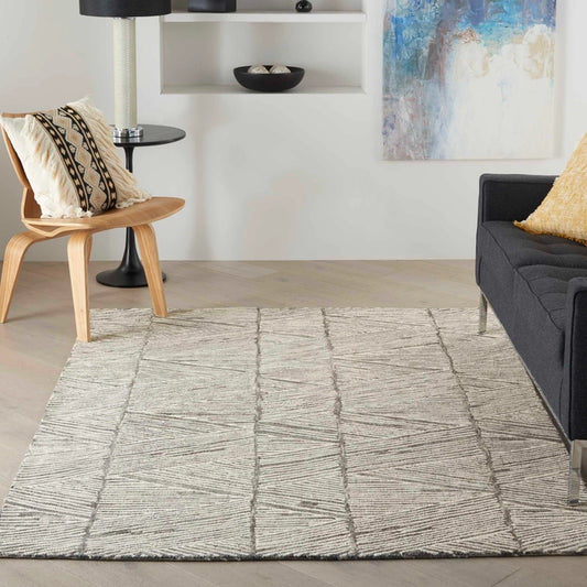 Nourison Colorado Rug Geometric Design luxury rug in a modern living room with wooden chair and dark sofa