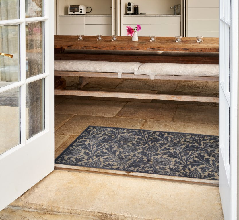 Turtle Mats Thistle Design indoor Mat placed at doorway with floral pattern in a kitchen setting