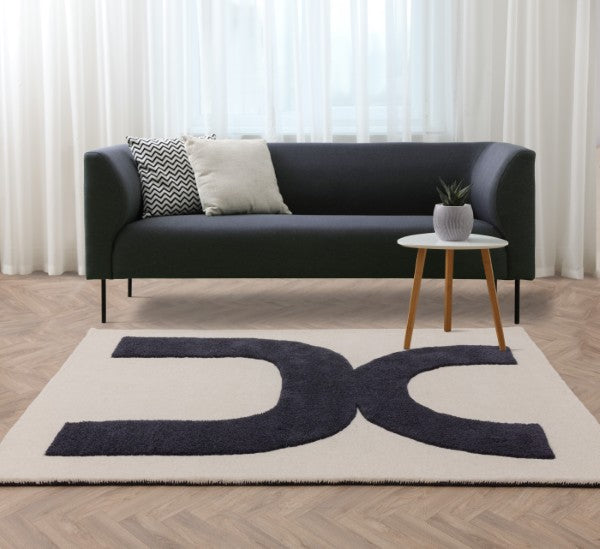 Asiatic luxury rug with Contemporary Design Canvas Rug featuring bold black patterns on cream background under modern sofa