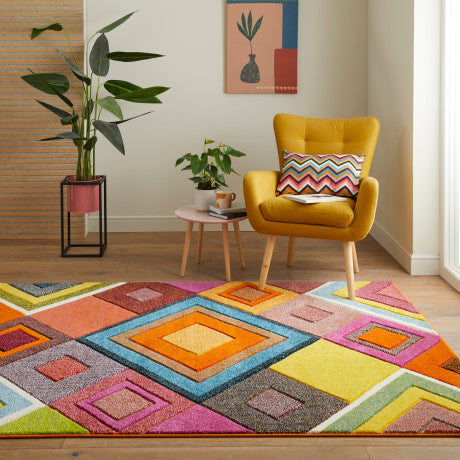 Bright living room with a colourful geometric concept looms designer rugs and a mustard yellow armchair