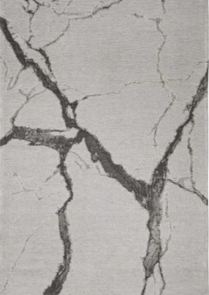 Textured gray surface with black cracks