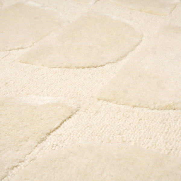 Close-up of a textured beige rug surface
