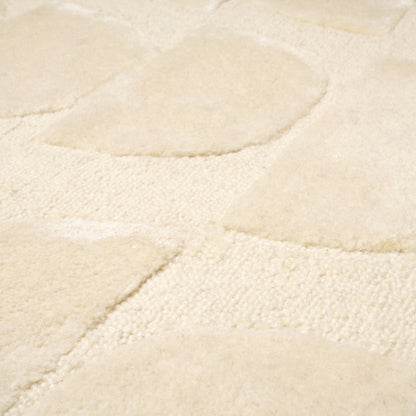 Close-up of a textured beige rug surface