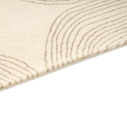 Close-up of a textured beige rug with wavy pattern on a white background