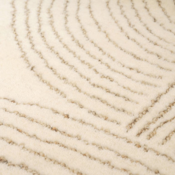 Close-up of a textured beige carpet with wavy pattern