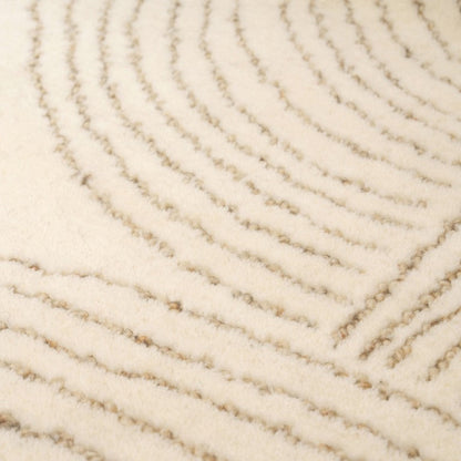 Close-up of a textured beige carpet with wavy pattern