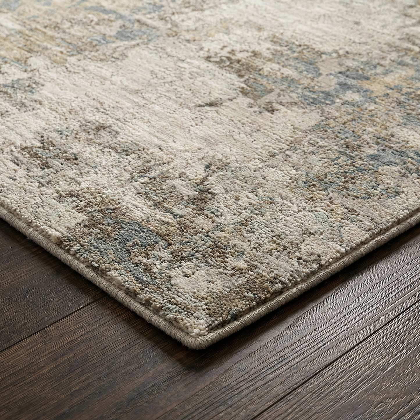 Textured area rug with a geometric pattern on a wooden floor
