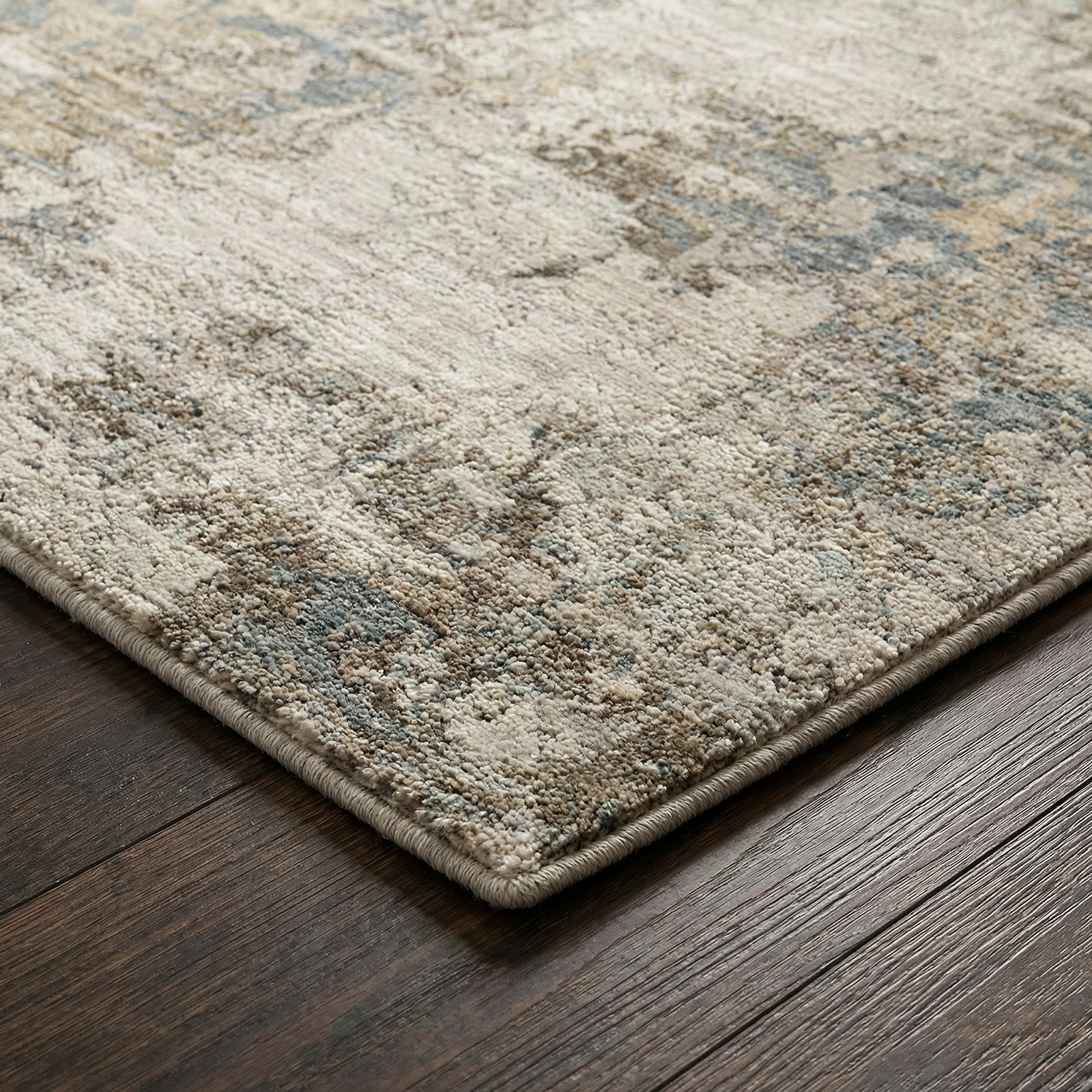 Textured area rug with a geometric pattern on a wooden floor
