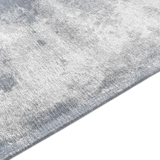 Grey textured rug on a white background
