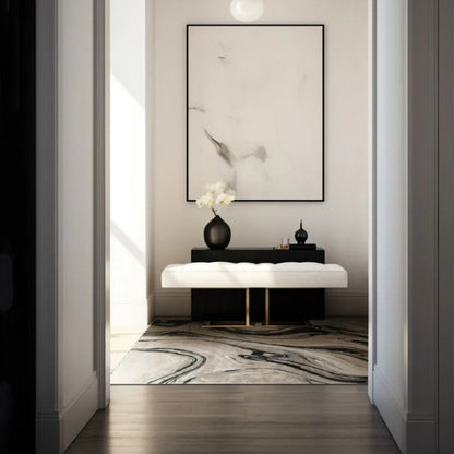 Modern interior design of a hallway with a light fixture, framed artwork, and decorative items.