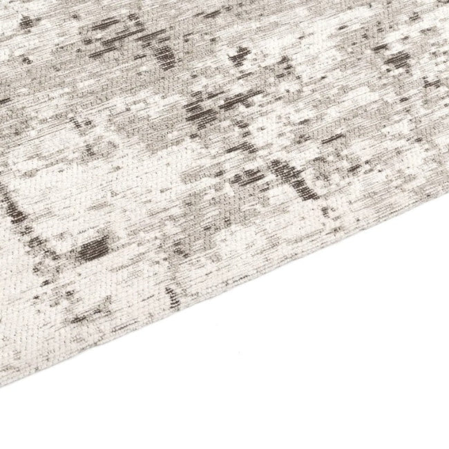 Close-up of a textured rug with a neutral color palette on a white background