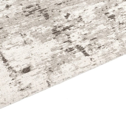 Close-up of a textured rug with a neutral color palette on a white background