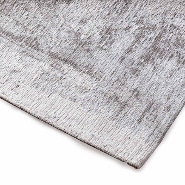 Gray textured rug corner on a white background