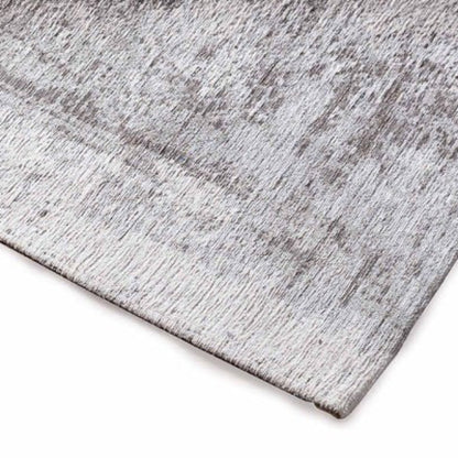 Gray textured rug corner on a white background