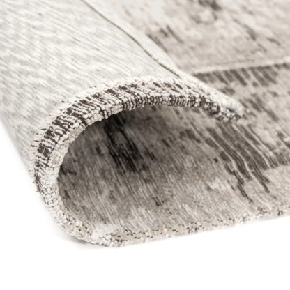 Roll of gray and white patterned rug on a white background