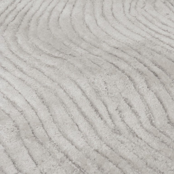 Close-up of a textured grey carpet with wavy patterns