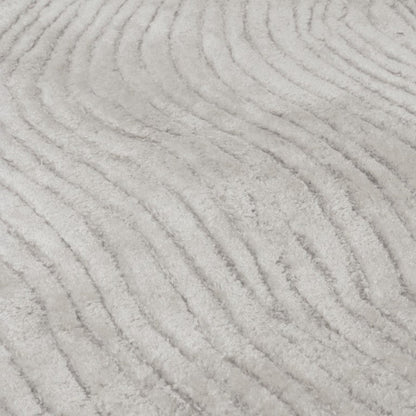Close-up of a textured grey carpet with wavy patterns