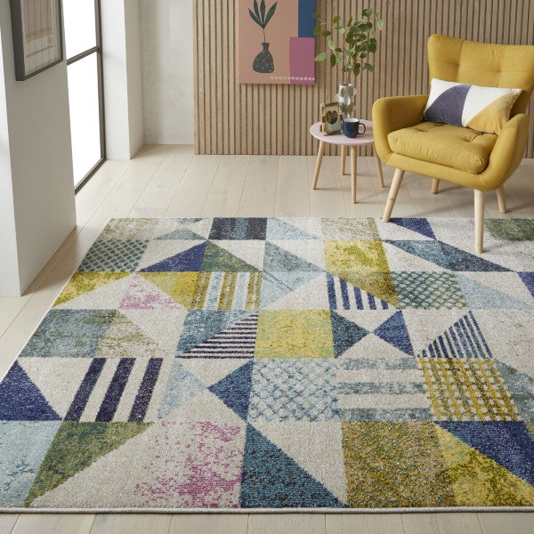 Concept Looms Carnaval Rug featuring a multicoloured geometric pattern on a soft luxury surface in a modern living room