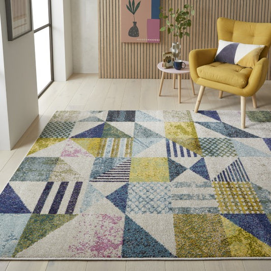 Concept Looms Carnaval Rug featuring a multicoloured geometric pattern on a soft luxury surface in a modern living room