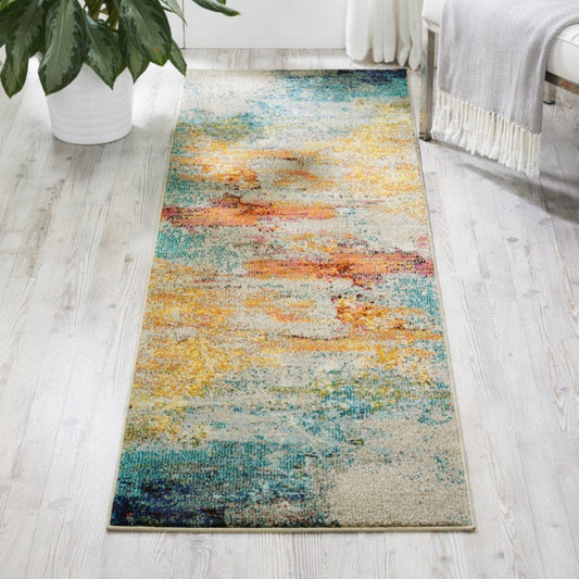 Colorful abstract runner rug on a light wooden floor with a plant and bed in the background.