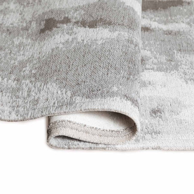 Close-up of a textured grey rug on a white background