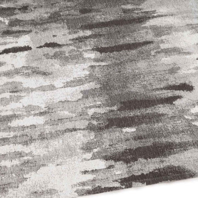 Textured fabric with a pattern of black, grey, and white stripes.