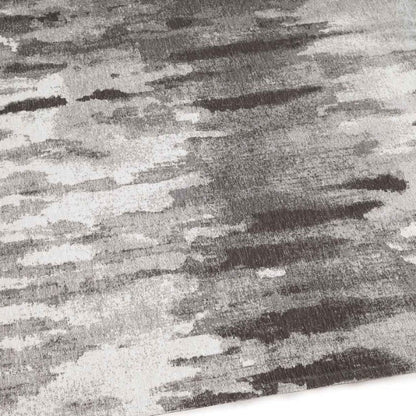 Textured fabric with a pattern of black, grey, and white stripes.