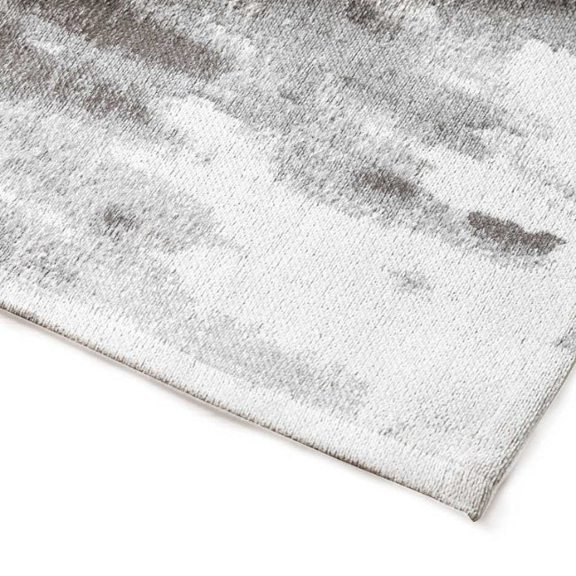Grey textured rug on a white background