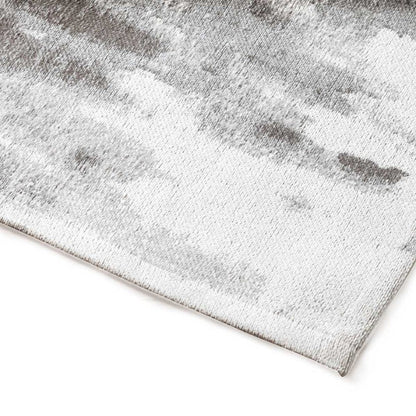Grey textured rug on a white background