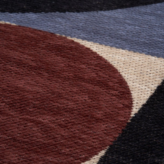 Close-up of a textured surface with geometric shapes in red, blue, and black.