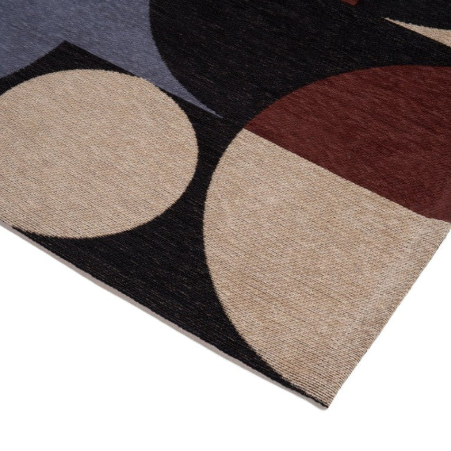 Geometric patterned rug with circular shapes on a white background