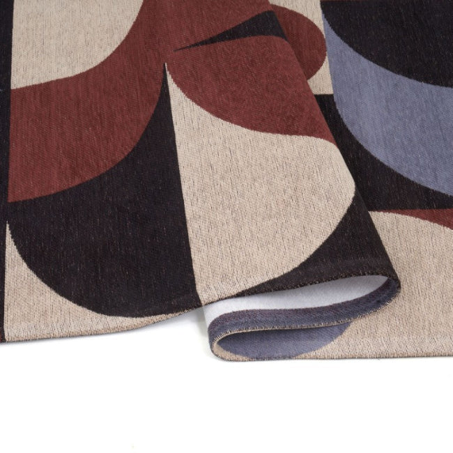 Close-up of a patterned rug with geometric shapes on a white background