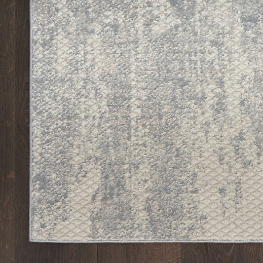 Textured grey rug on a wooden floor