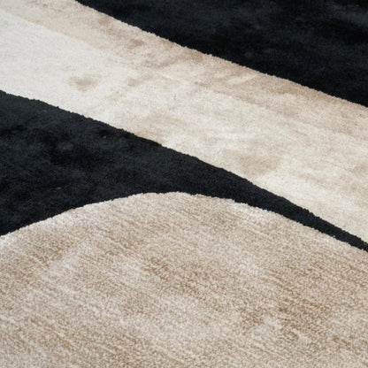 Close-up of a textured rug with black and beige patterns