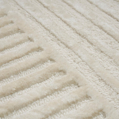 Close-up of a textured beige rug with wavy pattern